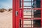Door handle of an old British red telephone box on a sandy beach in Studland, near Sandbanks, Dorset, UK