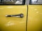 Door handle of old mythic french car with yellow car body