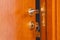 Door with inserted key in the keyhole and house icon on it