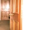 Door knob - brass handle on a dark wooden door inside the house