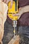 Door knob installing using yellow power drill, sawdust flying a