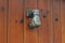 Door knocker in the form of a hand on wooden door in Rupit