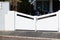 Door large metal gate white fence on home suburb street access house garden