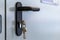 Door lock keys, Real estate concept door handle, Key insert and hold in metallic knob on white door horizontal