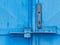 Door lock system detail. Blue industrial double door with rusty marks