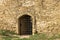 Door of medieval ancient fortress. Closed enter in the defensive stone wall.