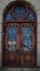 door. Old wooden entrance doors with a brass handle in the city. Arched door. A beautiful street door with an arch