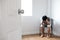 Door opened with depressed guy sitting in corner of empty room