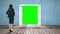 Door opening to green screen watched by businesswoman