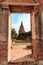 The door of the Ratburana Temple wall, looking the ancient Pagoda of King Borommarachathirat II in the distance