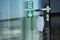 A door with sign exit with a face mask suspended on a door handle in a corporate building, close up. A reminder of safety measures