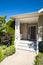 Door steps and concrete pathway leading to main entrance under the porch