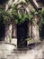 Door to a gothic chapel with ivy