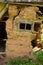 Door and window on the wall of a wooden and stone house