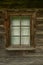 Door and window on the wall of a wooden and stone house