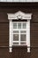 Door and window on the wall of a wooden and stone house