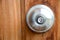 Doorknob silver stick blacked beautiful brown wooden door.