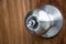 Doorknob silver stick blacked beautiful brown wooden door.