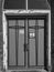 Doors on an old abandoned church in black and white