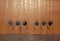 Doors with round windows portholes in a wooden high wall on a ship deck