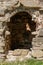 The doorway of a medieval castle ruins, reminiscent of a mysterious cave