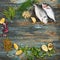 Dorado and natural raw ingredients for for healthy food on rough dyed wooden background.