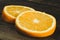 Dorange slices on an orange wooden background. Top view