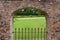 DORCHESTER, DORSET, UK - AUGUST 21ST 2020: An archway in an ornamental wall in an English stately home gives a view of the formal