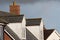 Dormer roof windows. Loft structures on modern town house buildings