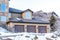 Dormer window over three door garage of home on a snowy neighborhood in winter