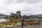 Dornie, Scotland; August 27th 2019: A Scottish bagpiper playing his musical instrument above Eilean Donan Castle