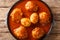 Doro Wat is Ethiopian stew of chicken thighs with eggs in a spicy sauce close-up in a plate. Horizontal top view