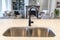 Double basin undermount sink at the kitchen island of home with black faucet