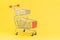Double baskets shopping cart or shopping trolley on yellow background using as online shopping, e-commerce, supermarket consumer