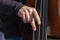 Double bass, hands playing and plunk contrabass strings, musical instrument player close up