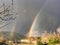 Double beautiful rainbow on countryside on blooming at springtim