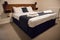 Double bed with bedding in clean simple basic hotel room