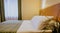 Double bed in a simple and nicely furnished cozy hotel room during daytime