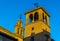 Double bell towers in Antequera, Spain illuminated by the setting sun