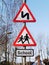 Double bend first to left sign and School children crossing sign