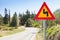 Double bend, triangular yellow warning roadsign