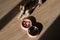 A double bowl for slow feeding and a bowl of water for the dog. Top view of a jack russell terrier dog near a pink plate