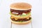 Double burger hamburger tomatoes lettuce cheese wooden board