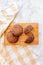 Double Chocolate Chip cookies on a wooden block and marble background