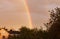 Double colored rainbow in the sky after rain in the suburbs