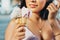 Double cone ice cream holding by young beautiful woman