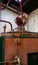 Double distillation process of cognac spirit in Charentias copper still pots and boilers in distillery in Cognac white wine region