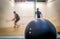 Double dot squash ball and two players in the background