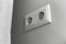 Double European electrical socket on wall at home in modern design, gray wall color photo