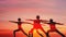 Double exposue background of group of caucasian people having yoga workout outdoors with overlay background of sunset sky